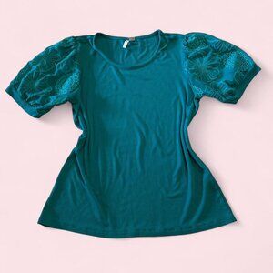 Teal puff sleeve top with floral embroidery.